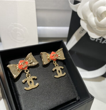 Chanel orange bow engraved earrings